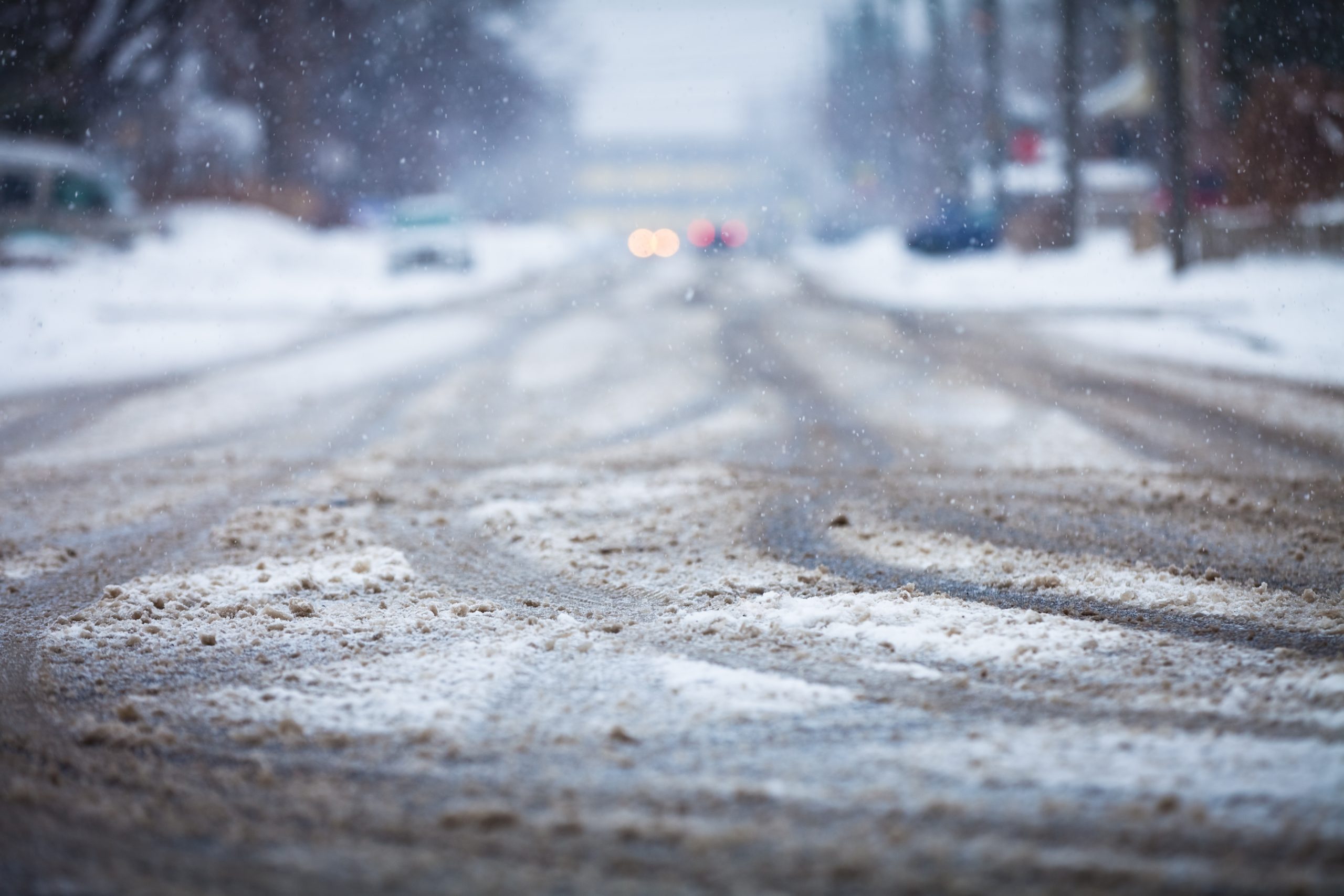 snow-covered-road-the-marks-of-wheels-P9MQ28C-scaled.jpg